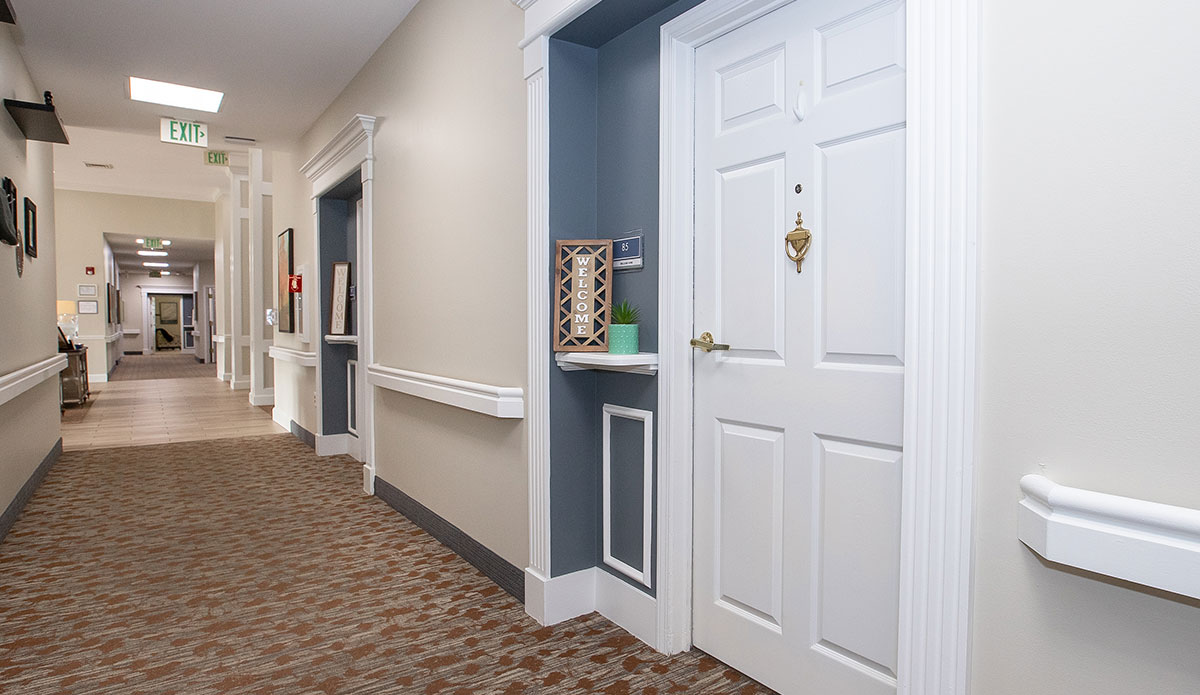 hallway featuring a closed door with a round doorknob on the right side.