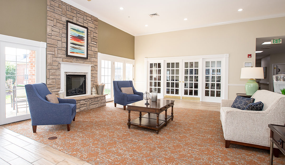 Inviting living room with a warm fireplace and plush couches for lounging.