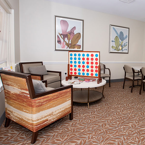 A room with a table and chairs, ready for a fun board game session.