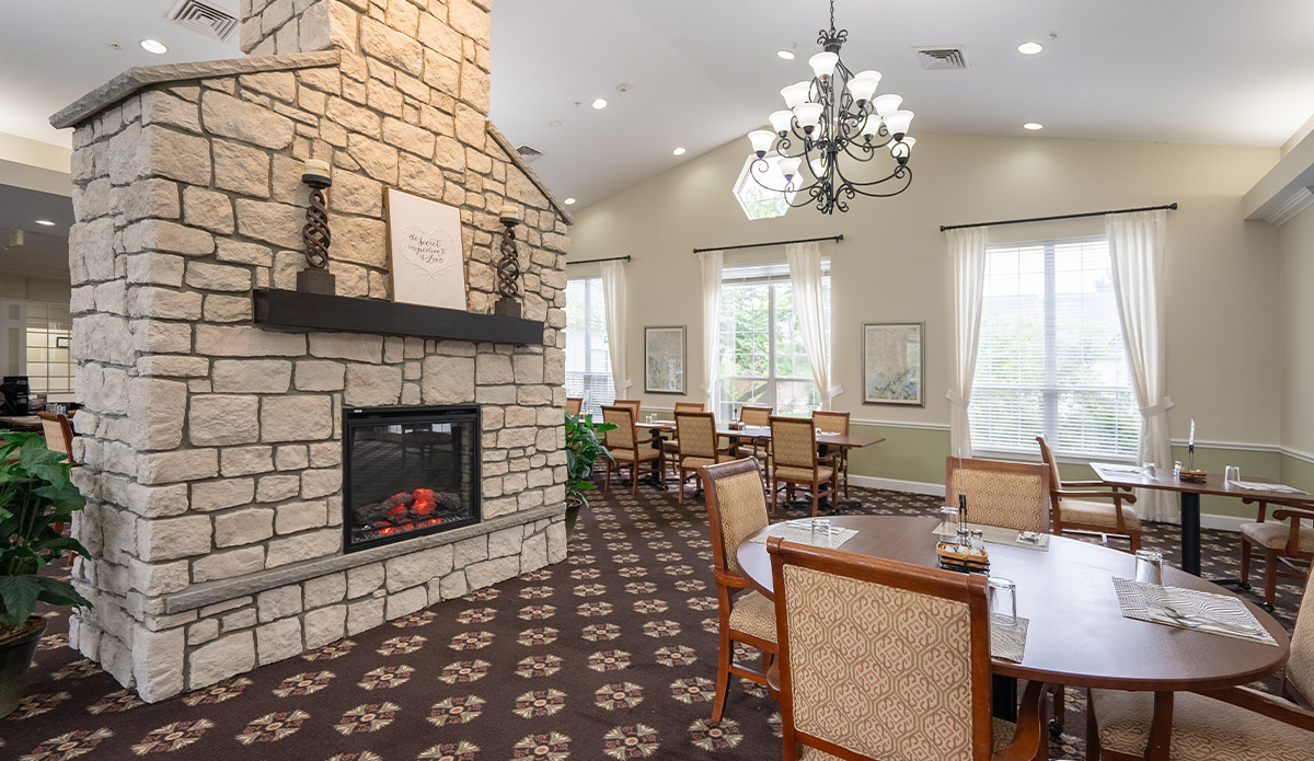 Bright and welcoming dining area at a senior living community, with neatly arranged tables and cheerful ambiance.