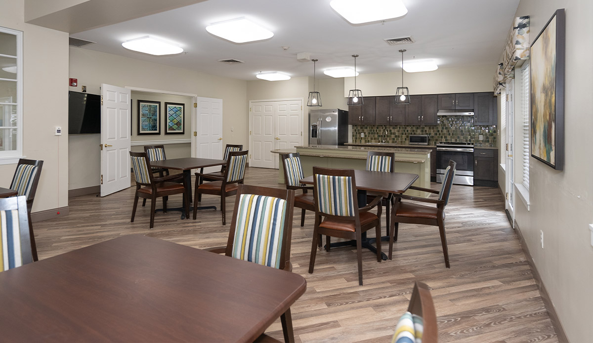 Bright and welcoming dining area at a senior living community, with tables arranged for residents to enjoy meals together.
