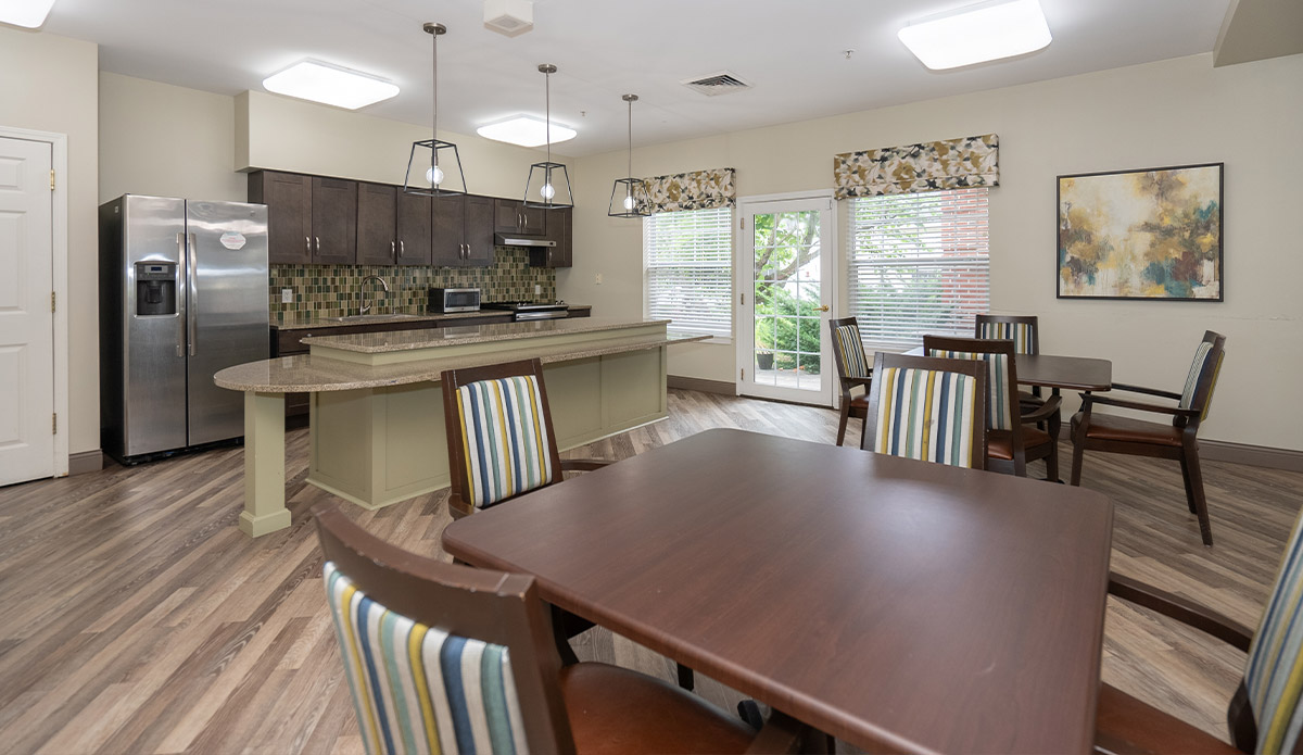 Bright and welcoming dining area at a senior living community, with tables arranged for residents to enjoy meals together.