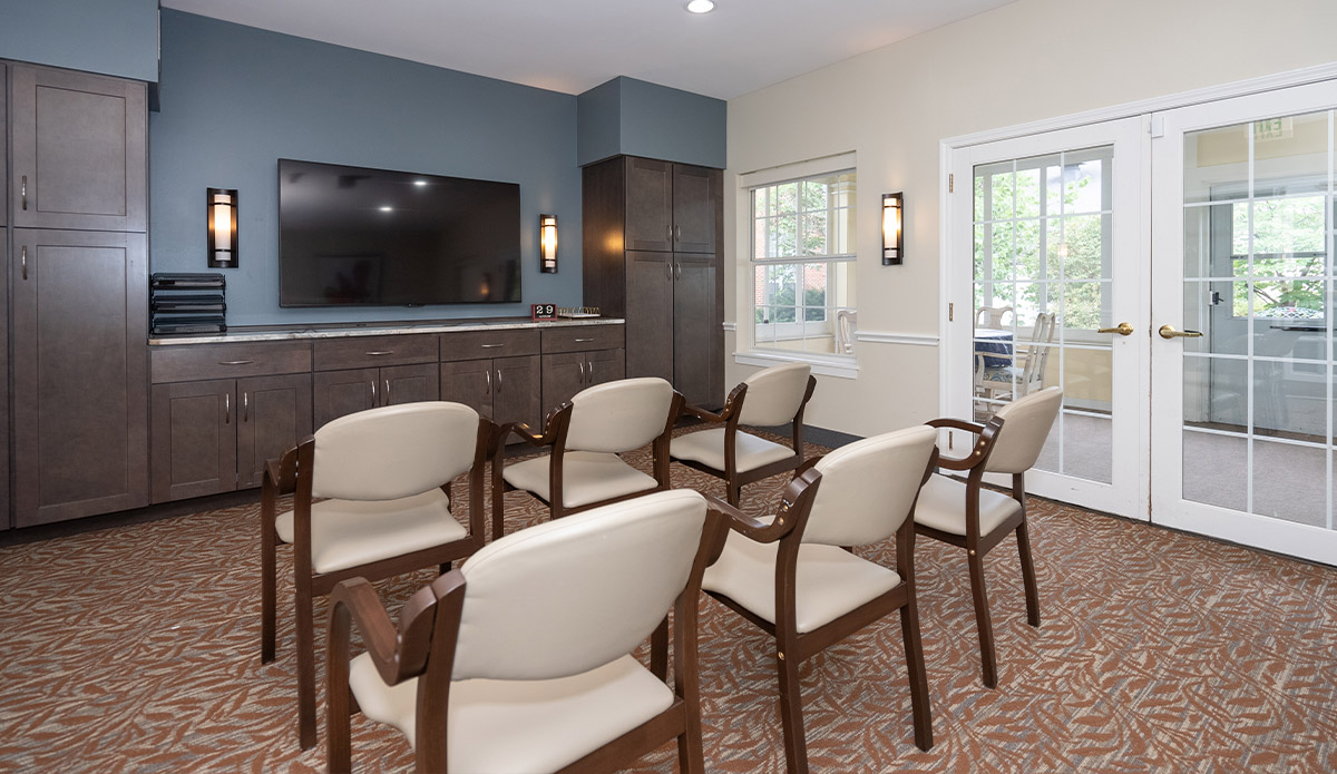 A simple room with chairs set up for viewing a television.
