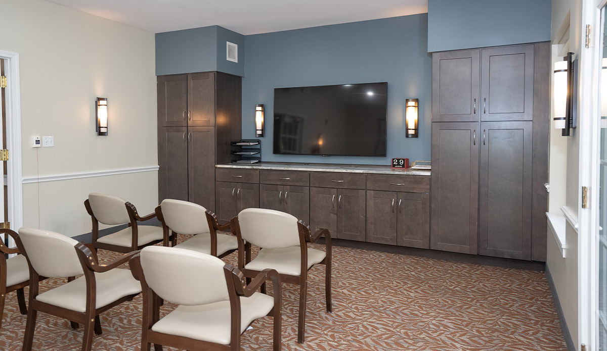 A simple room with chairs set up for viewing a television.