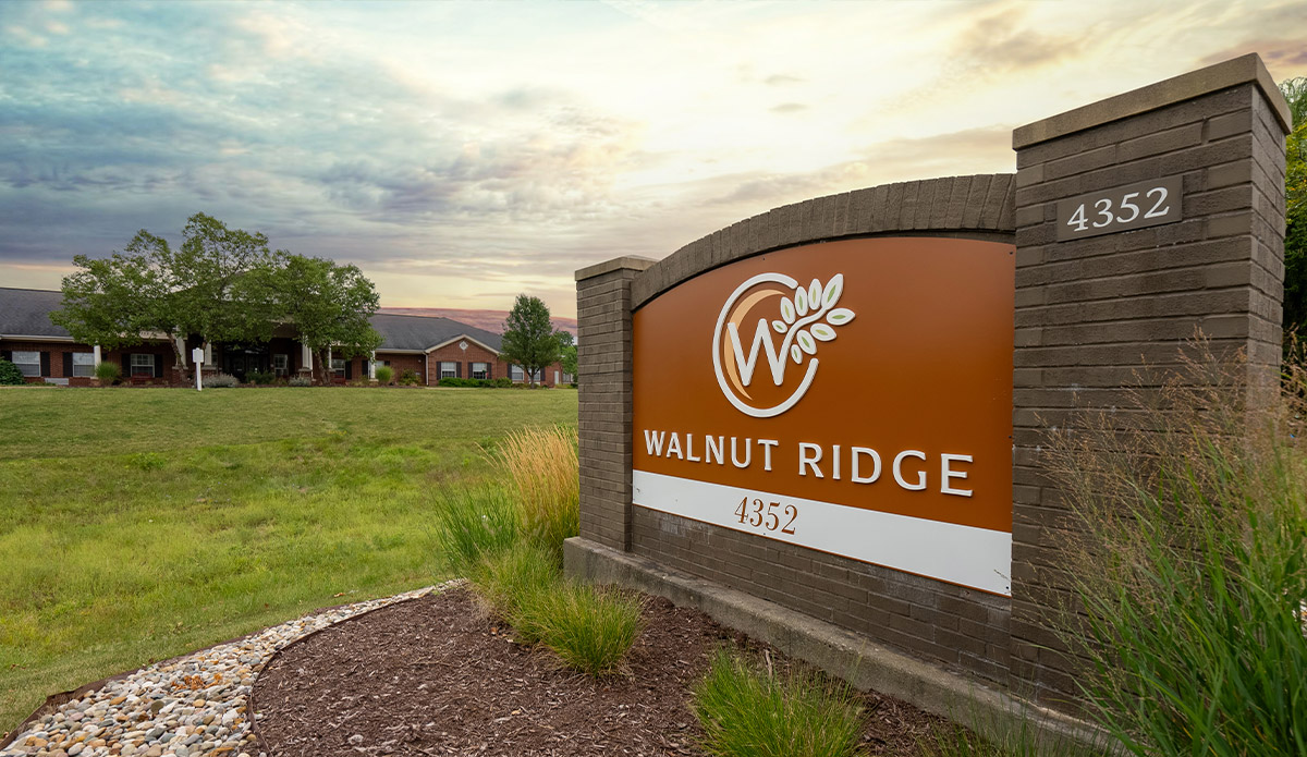 Walnut Ridge Apartments in Kansas City, KS, showcasing modern architecture and lush landscaping.